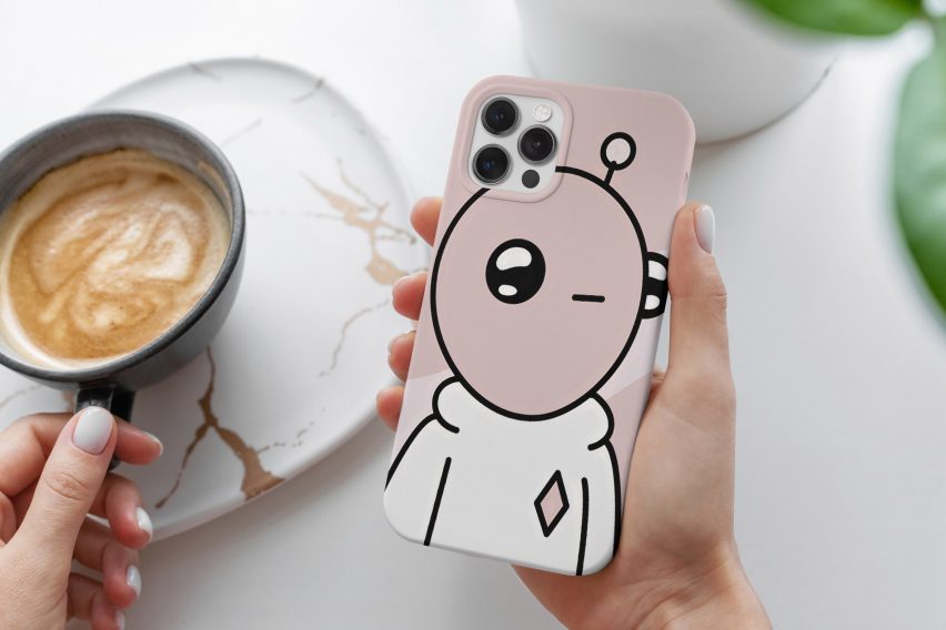 A photograph of someone holding a phone case with a cartoon-like image on the front