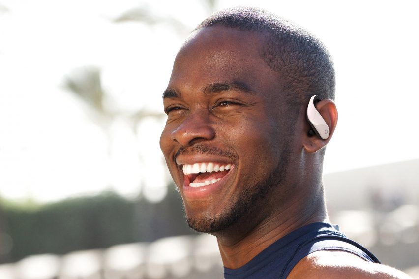 A photograph of a man wearing the earbuds