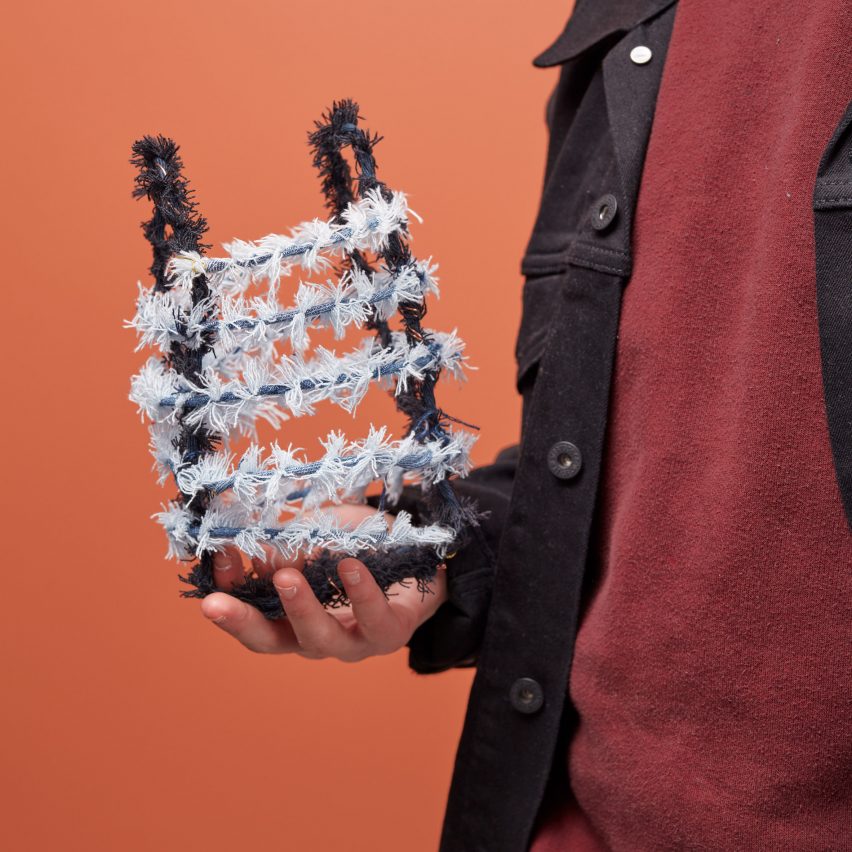 A person holding up a new material made from jeans
