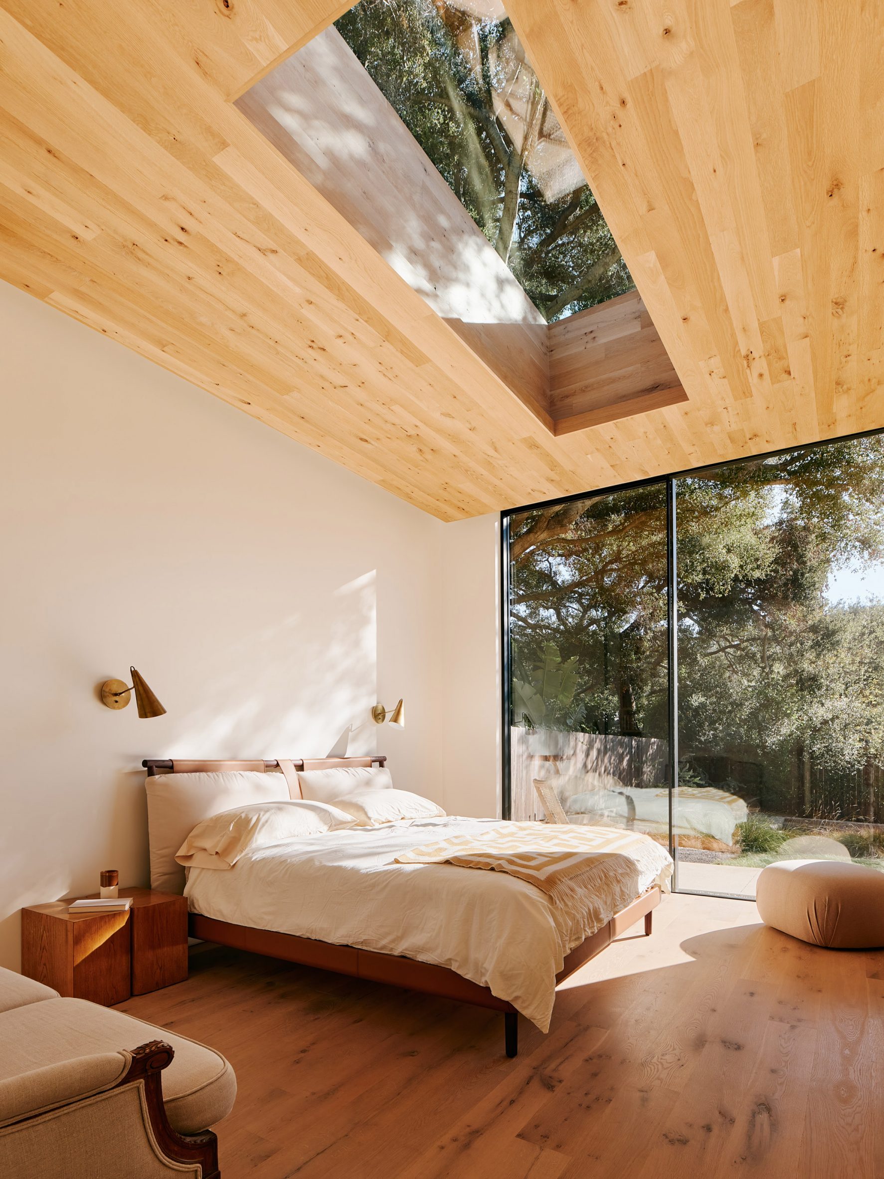 bedroom with wooden ceiling and skylight