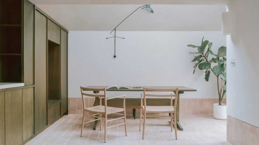 Dining room interior of Aperture House by Studio McW with wooden cabinet, table and chairs