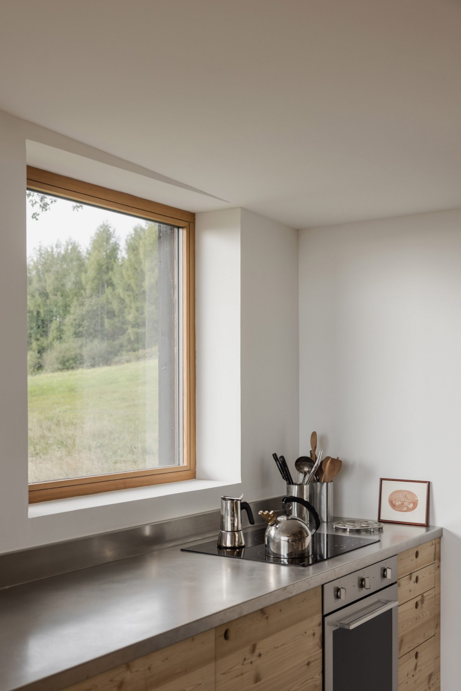 Image of a kitchen with squared window looking out to the hills