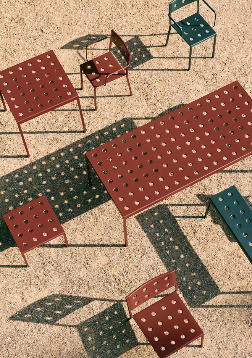Red and navy Balcony tables and chairs photographed from above on a sandy floor