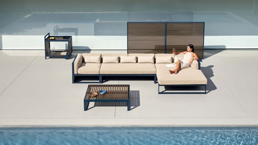Blue-grey serving cart, coffee table, sofa and partition situated by an outdoor pool setting