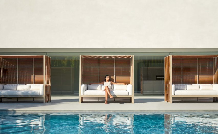 Three white DNA sofas with shuttered frames situated next to an outdoor pool