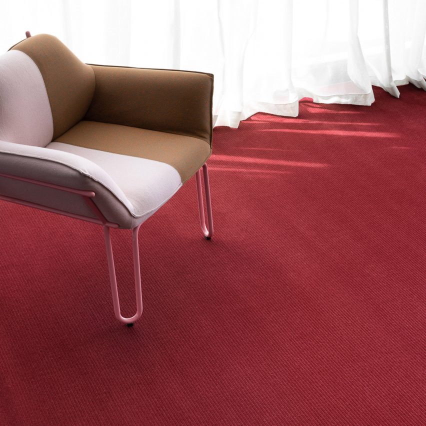 Red Era Wilton carpet by Signature Floors with a pink and brown armchair