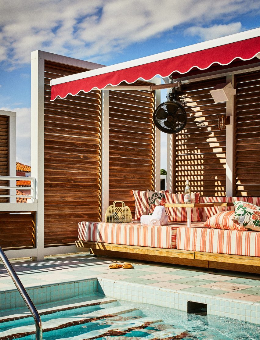 A rooftop pool and red seating