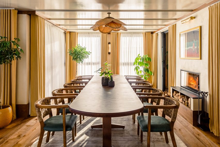 Communal dining room inside The Gessner with oblong wooden table and matching chairs