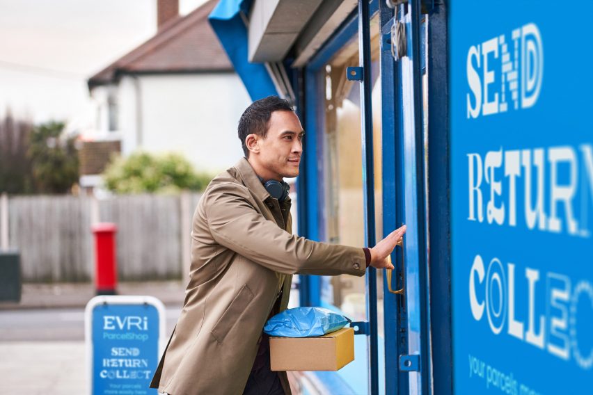 Man enters shopfront covered with blue Evri collection point signage