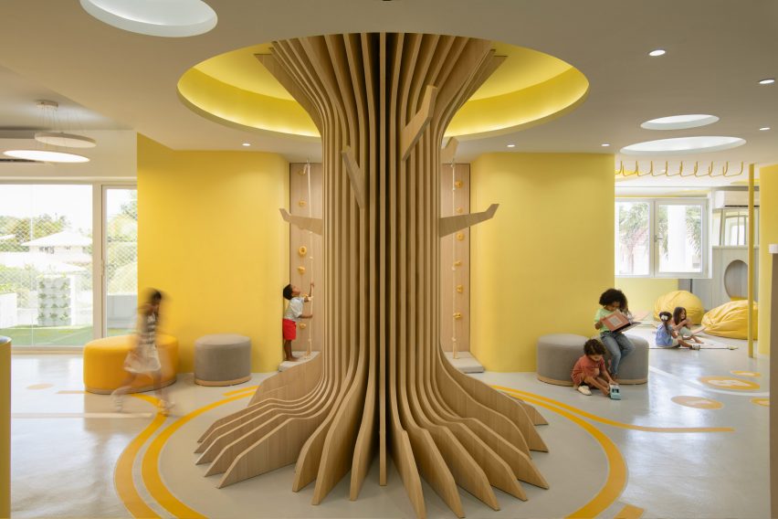A wooden tree trunk inside a lobby
