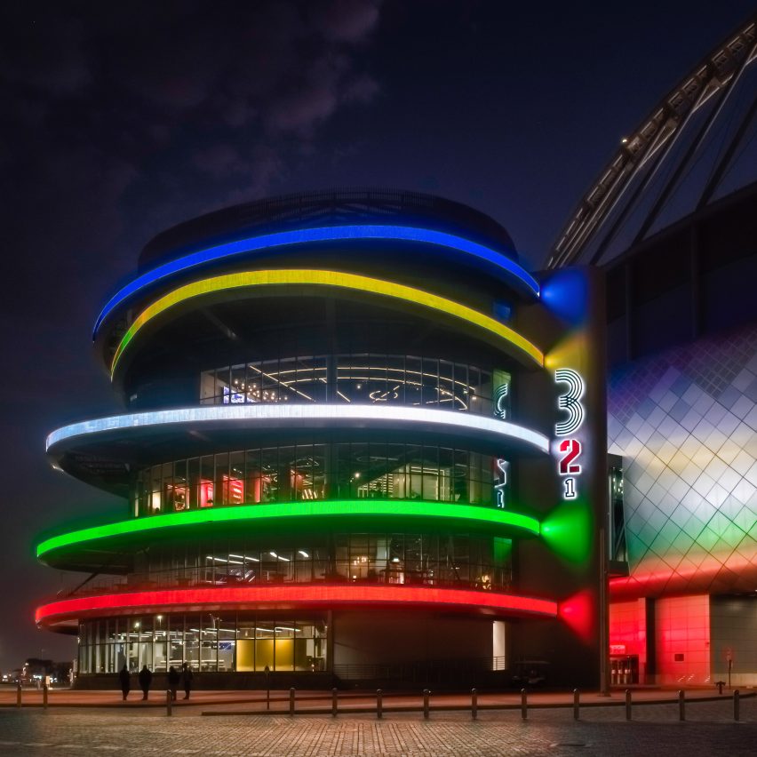 Olympic coloured rings surround the tubular building
