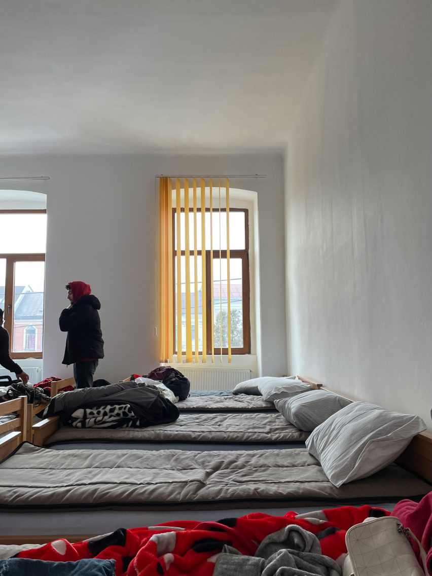 Room with four single beds lined up in camp for refugees of Ukraine war