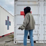 Katerina Kovalenko in front of Red Cross containers after fleeing from the Ukraine war