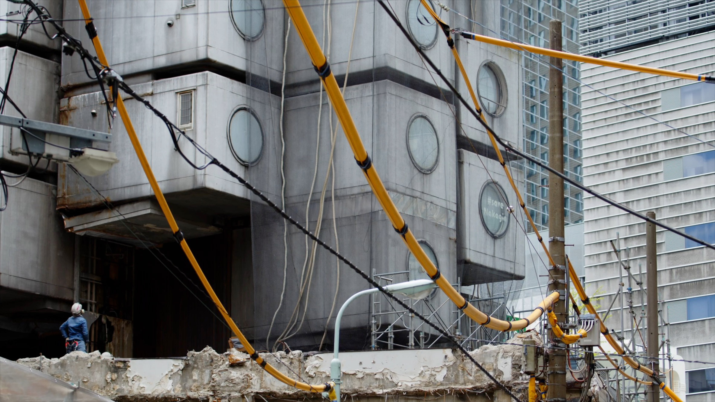 Image of the concrete structure being revealed at the Nakagin Capsule Tower