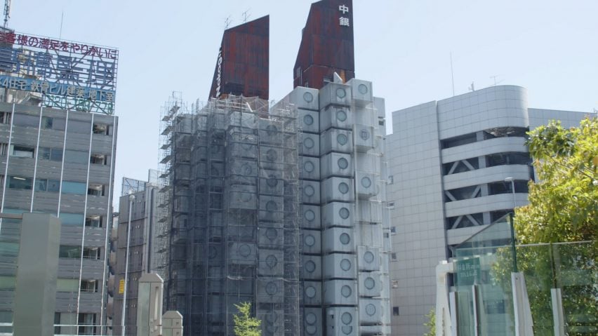 Image of the Nakagin Capsule Tower surrounded by scaffolding
