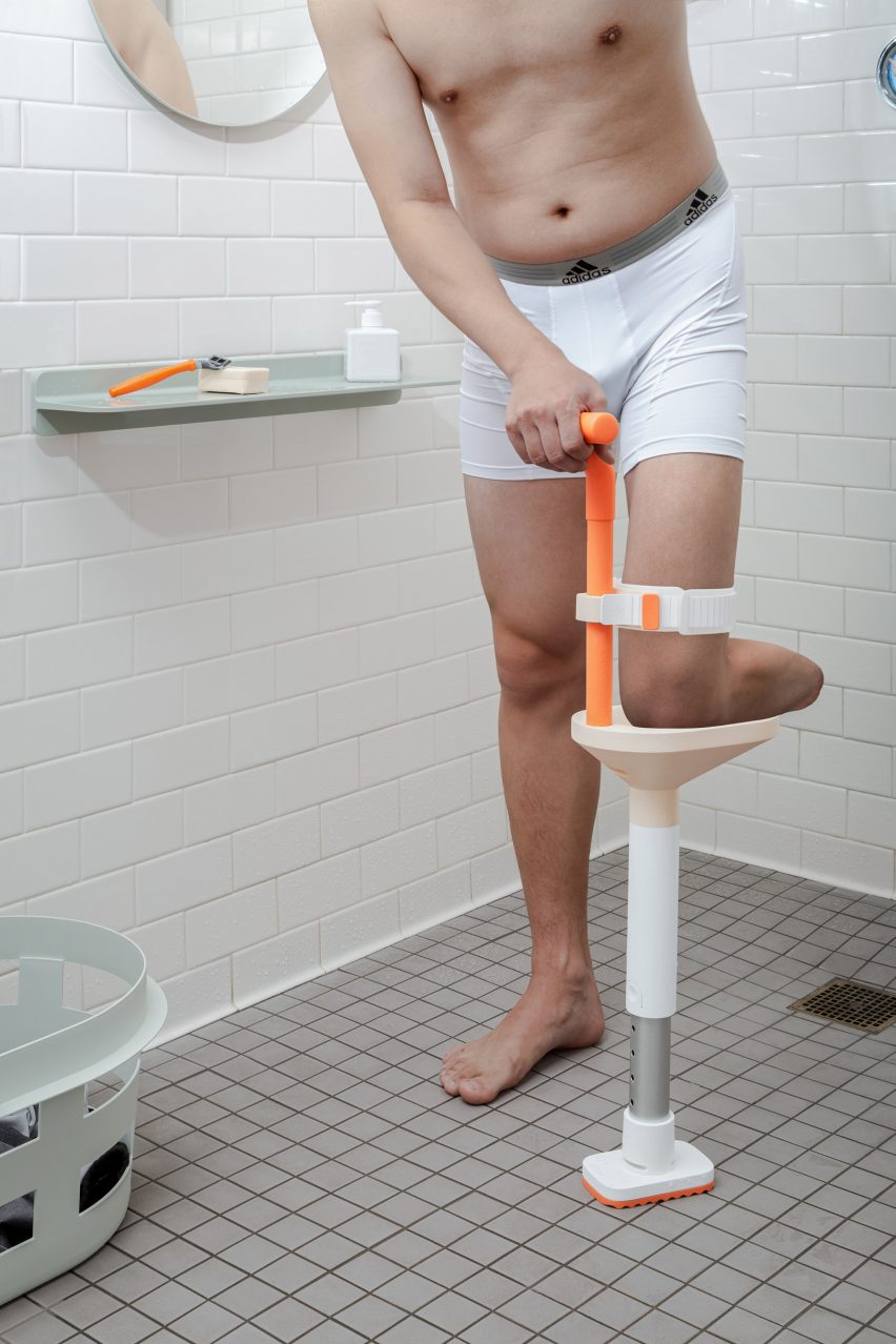 Below-knee amputee leaning on a Lytra shower leg prosthesis