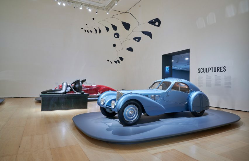 A blue car inside a museum