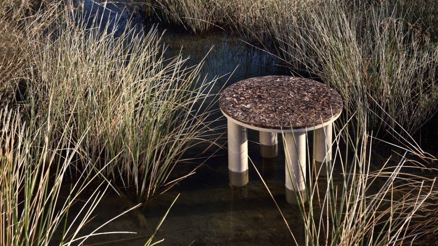 Round Oceanides table with four legs in a grassy wetland