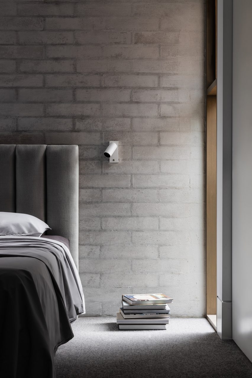 Bedroom interior of Ripponlea House with brick walls and simple grey bed