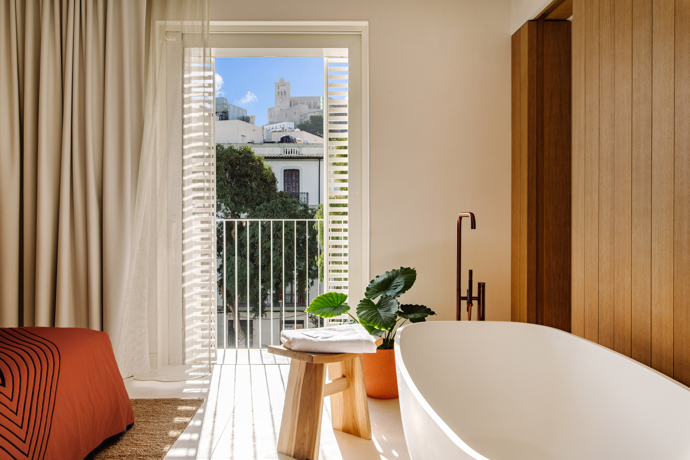 Interior image of a bedroom with a freestanding bath tub at The Standard Ibiza