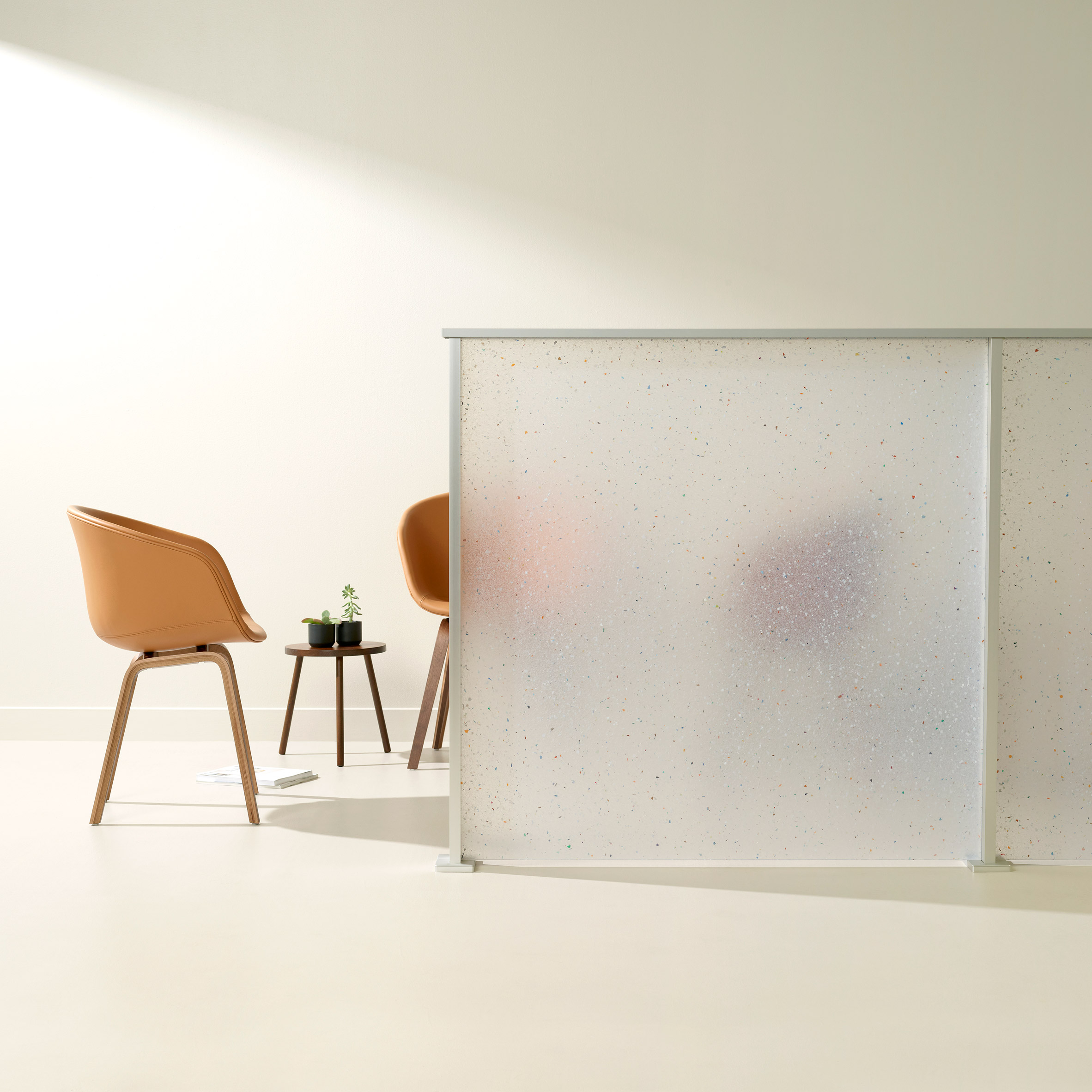 Flek Pure by 3form used as a partition wall with chairs behind