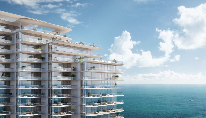 glass tower side and ocean in background