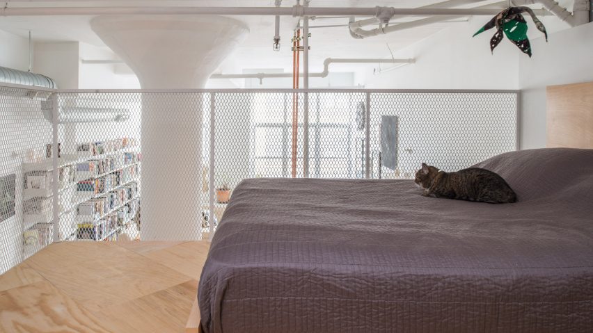 Mezzanine bedroom in white-walled apartment