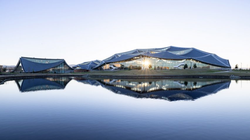 Image of Google's Bay View campus reflecting in a lake