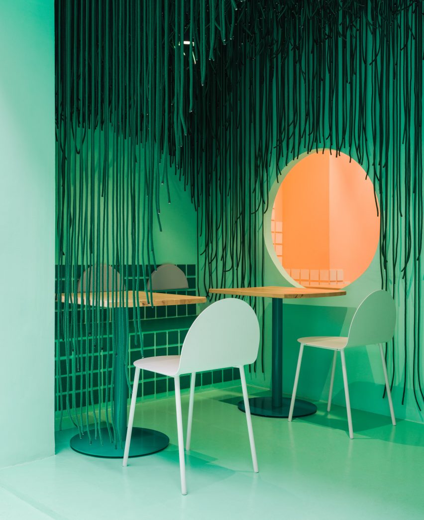Porch with green chairs and suspended ropes in Baovan restaurant