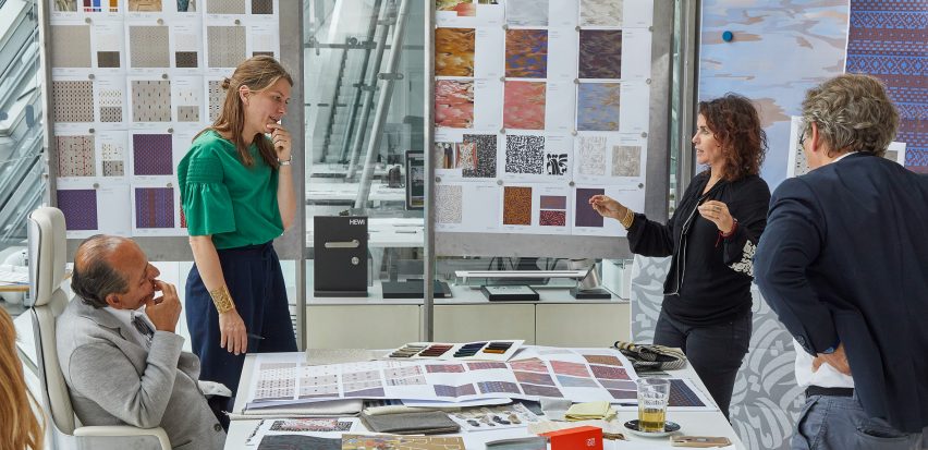 Designers discussing fabrics over a table