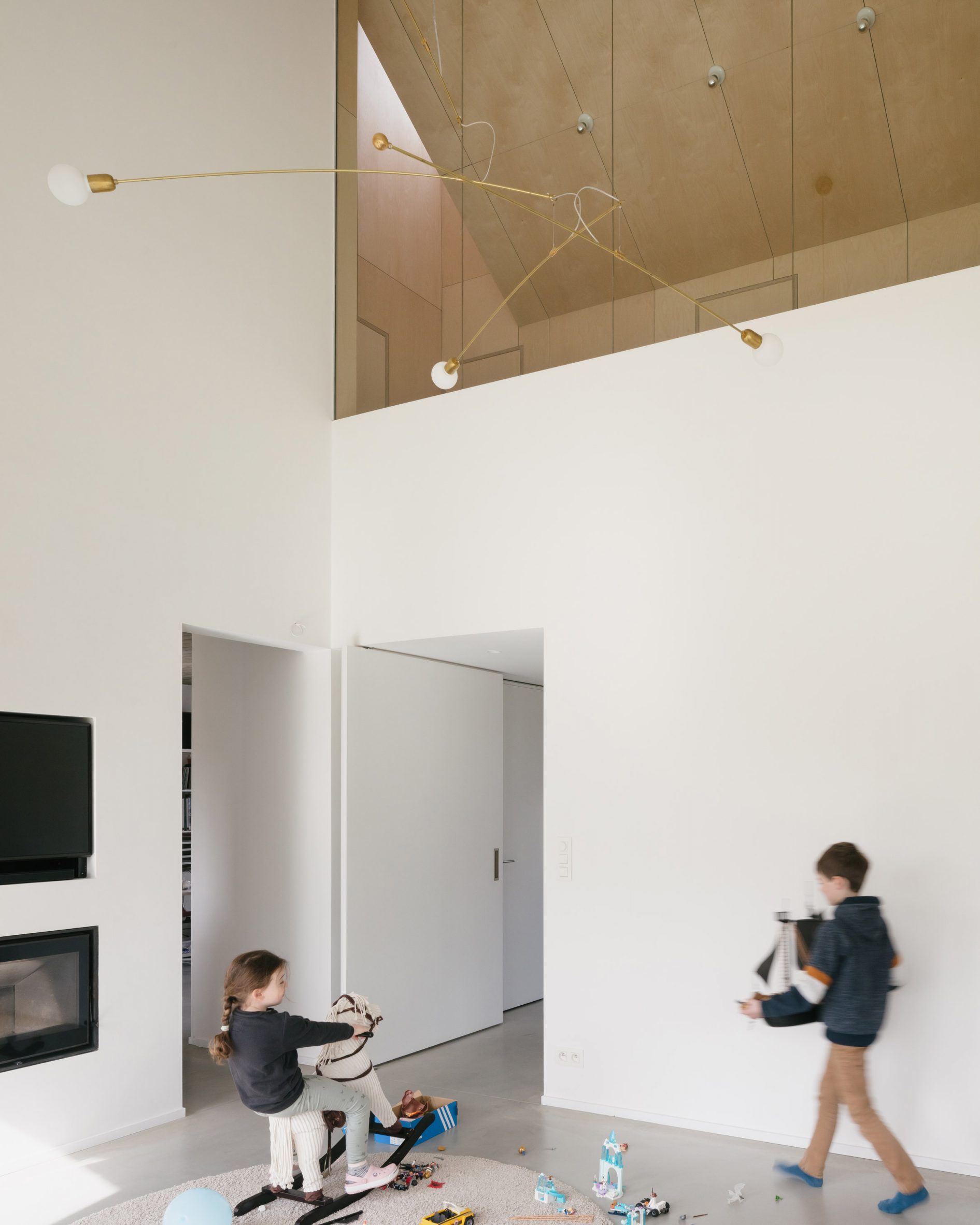Children playing in white-painted living area