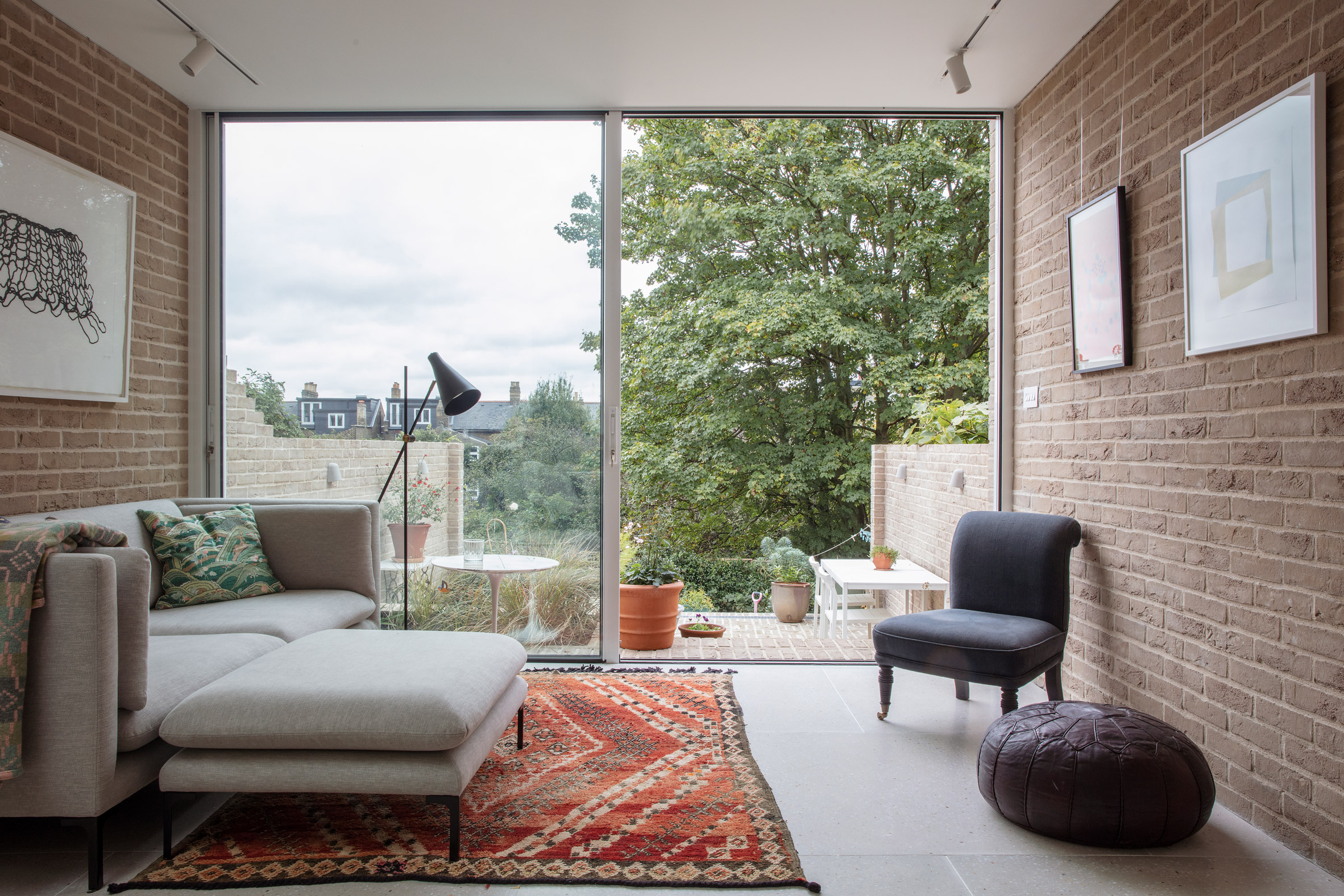 Image of the lounge area that leads out to a sunken garden at the london house extension and gallery