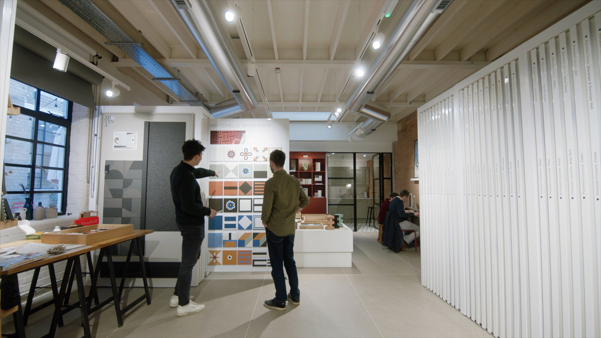 Two people looking at tiles at Domus's flagship store