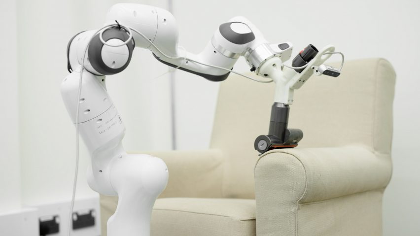 A Dyson robot arm cleaning an armchair