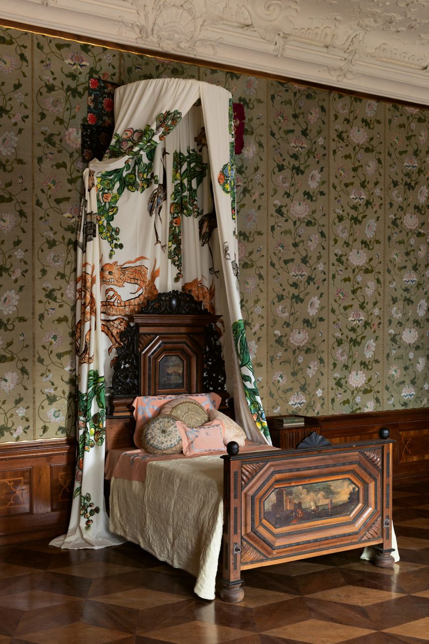 Hollenegg Fantasy fabric by Hanna-Kaisa Korolainen hung above a bed at Schloss Hollenegg castle