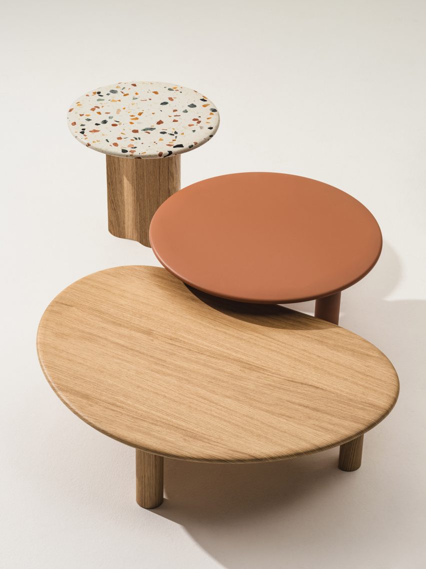 Photograph showing small, medium and large Ghia tables in natural wood, red paint and terrazzo