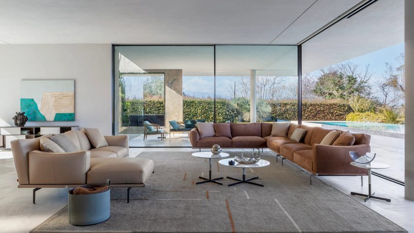 Two Happy Jack sofas in an open living room with floor the ceiling windows