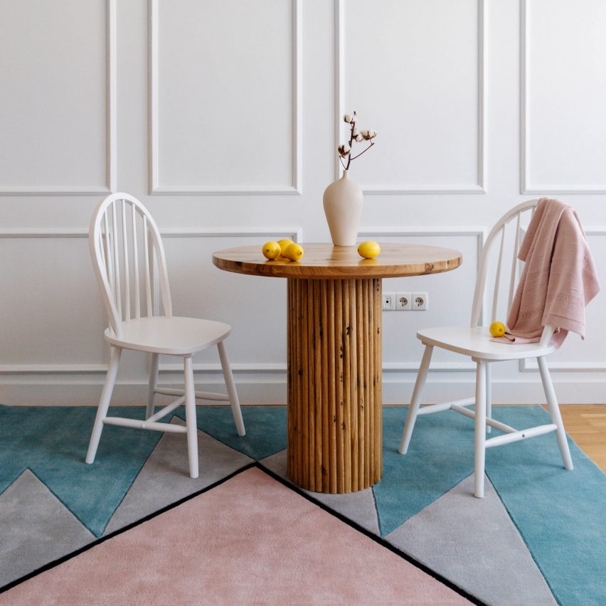 Blue and pink Harmony rug with two white chairs and a side table 