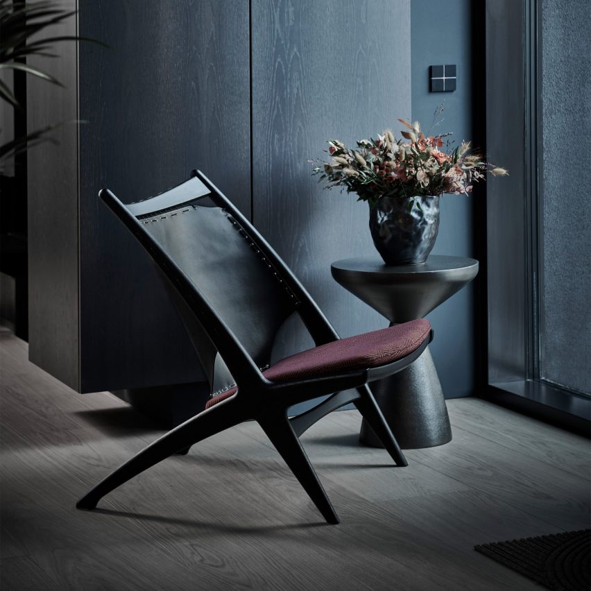 Black Krysset chair with a burgundy seat cushion in a dark room