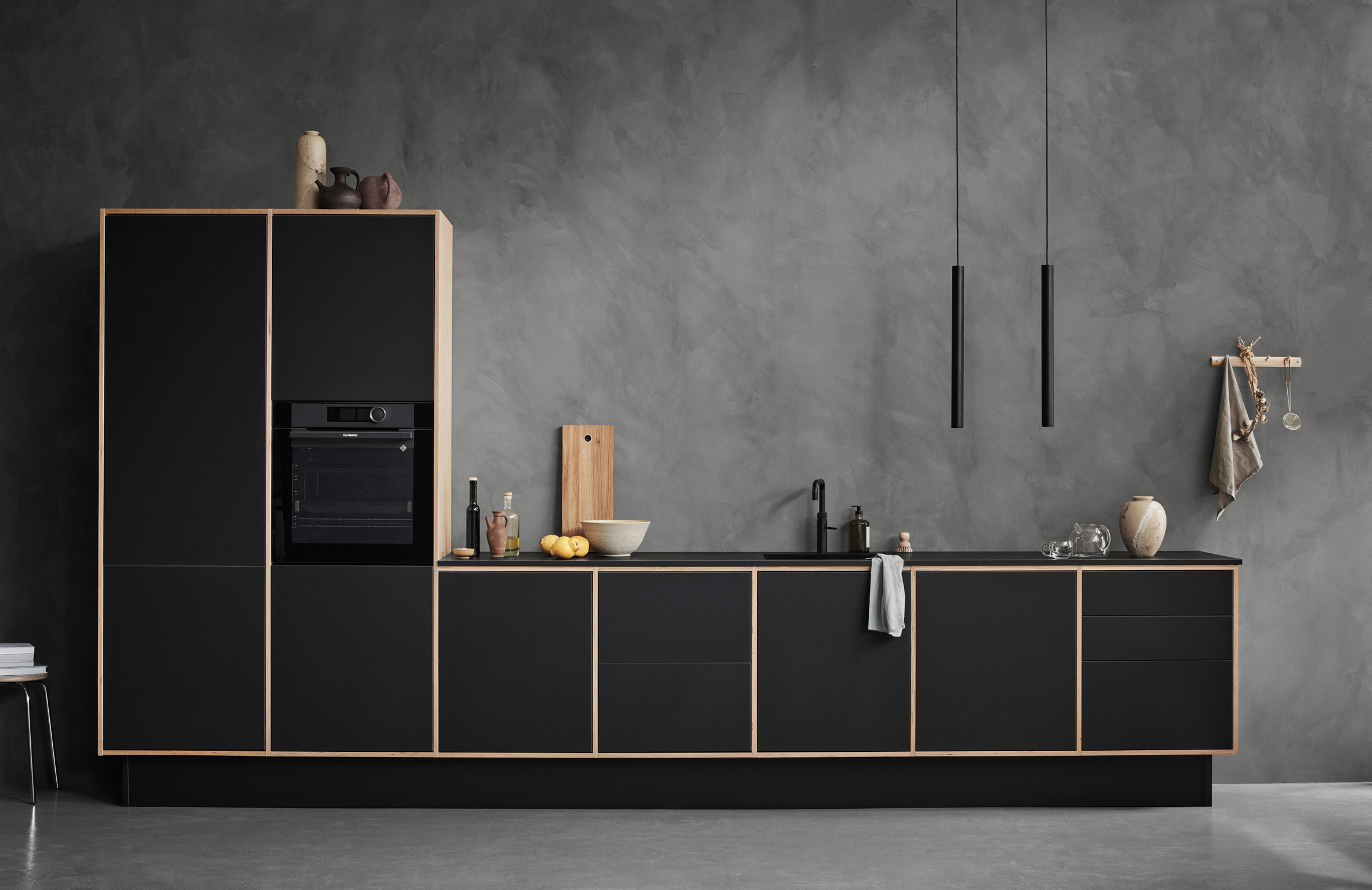 Birch and black LoopKitchen by Stykka in a concrete room