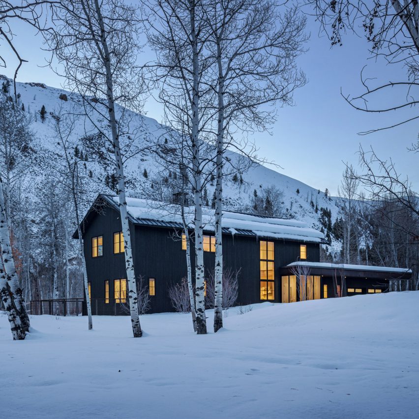 Black clad barn house in the snowy mountains