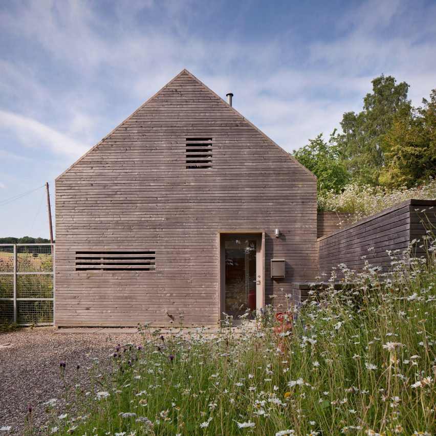 Gable end of Mary Arnold Forster Architects' timber clad barn structure in a grassy area