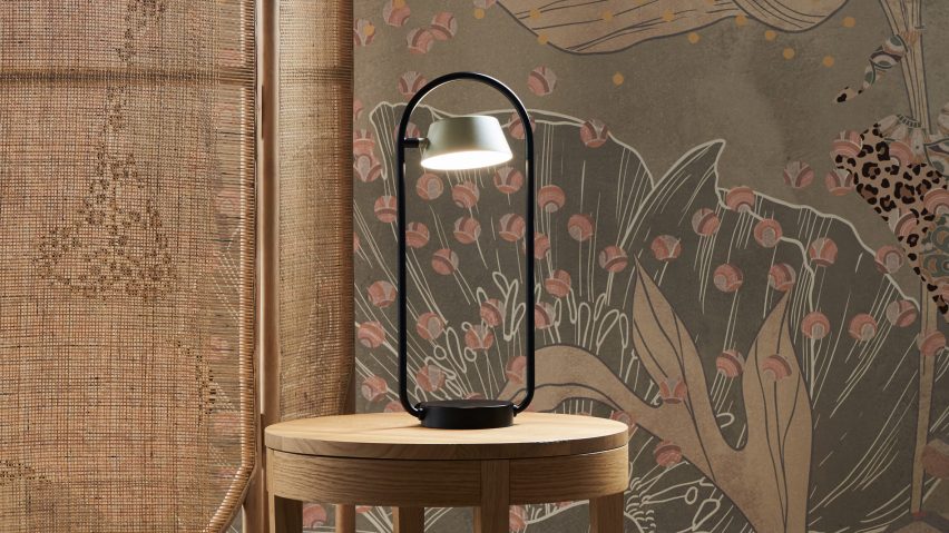 OLO lamp on a wooden table against a wallpapered background