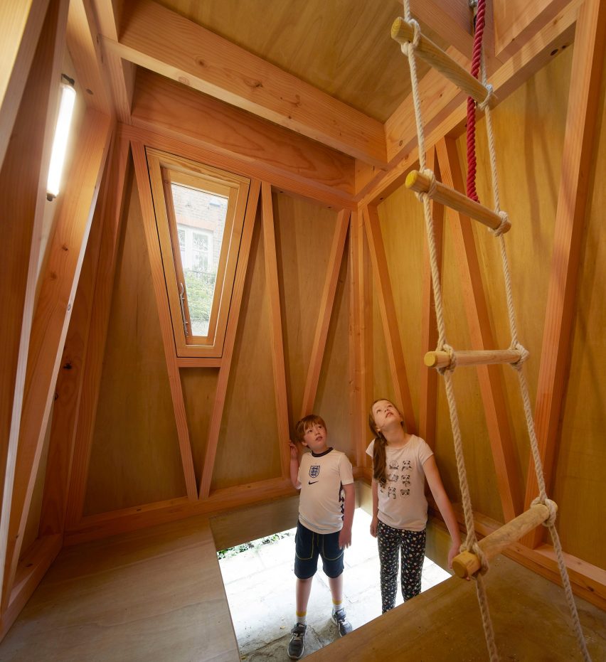 Wooden playhouse with rope ladder