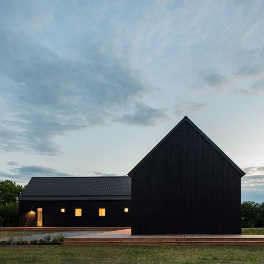 Black stained L-shaped barn house by Ravi Handa Architects