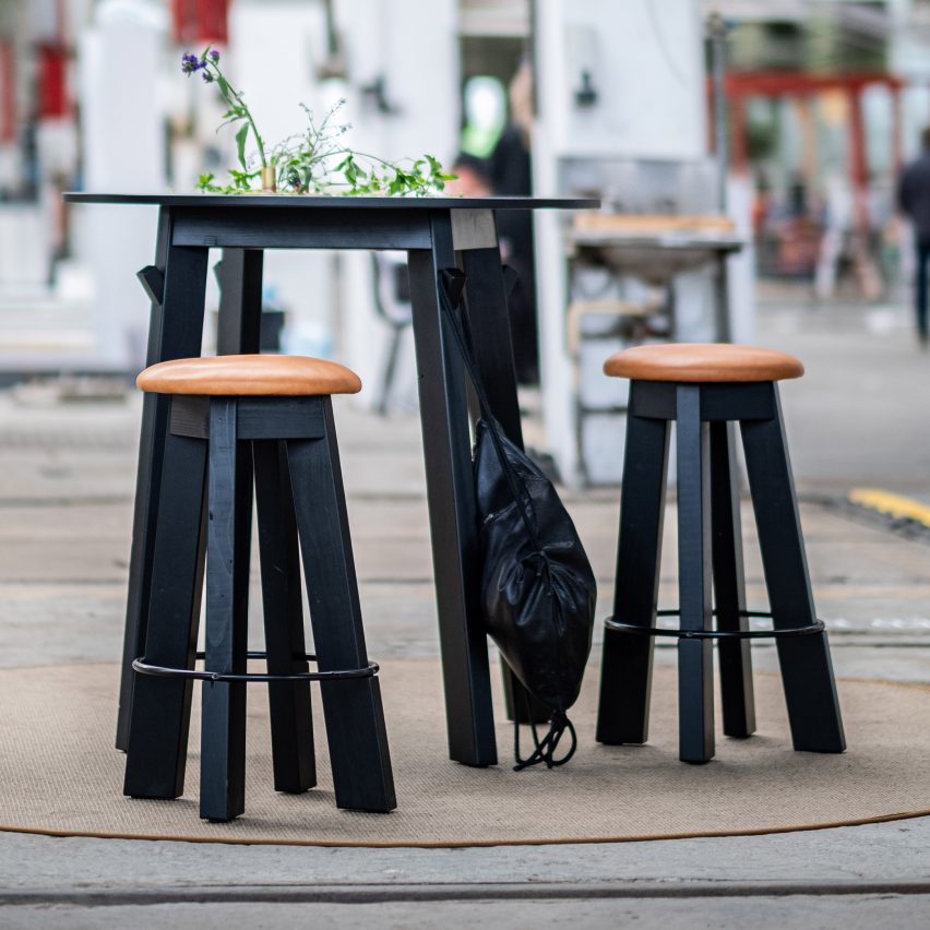 Black wooden stools and matching table