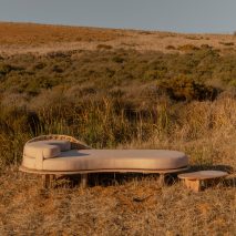 Sayari daybed and side table on a grassy hill