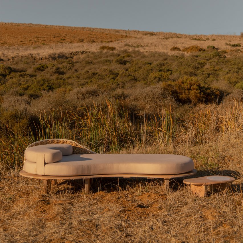 Sayari day bed and side table on a grassy hilltop