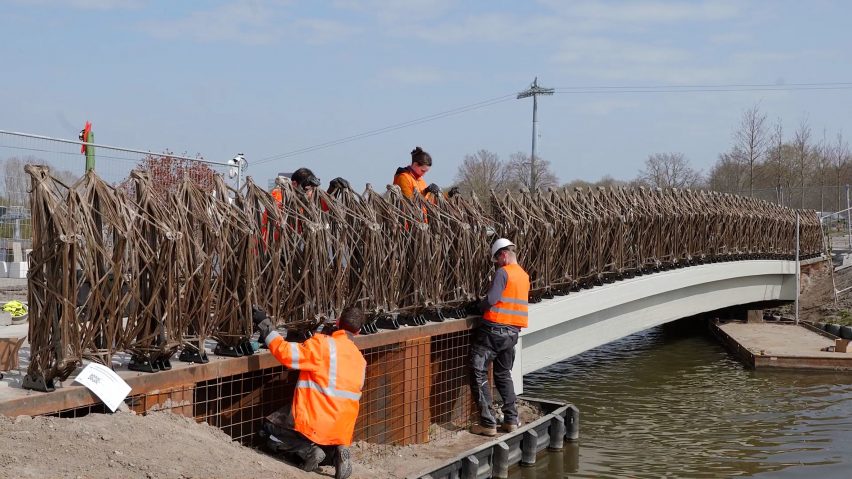 Workers install the first Smart Circular Bridge in Almere