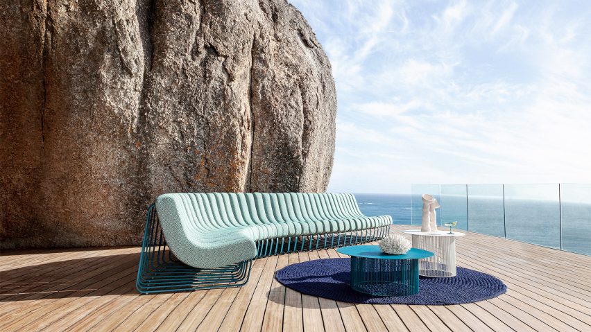 Songololo sofa in an aqua blue colour on an outdoor deck by the sea